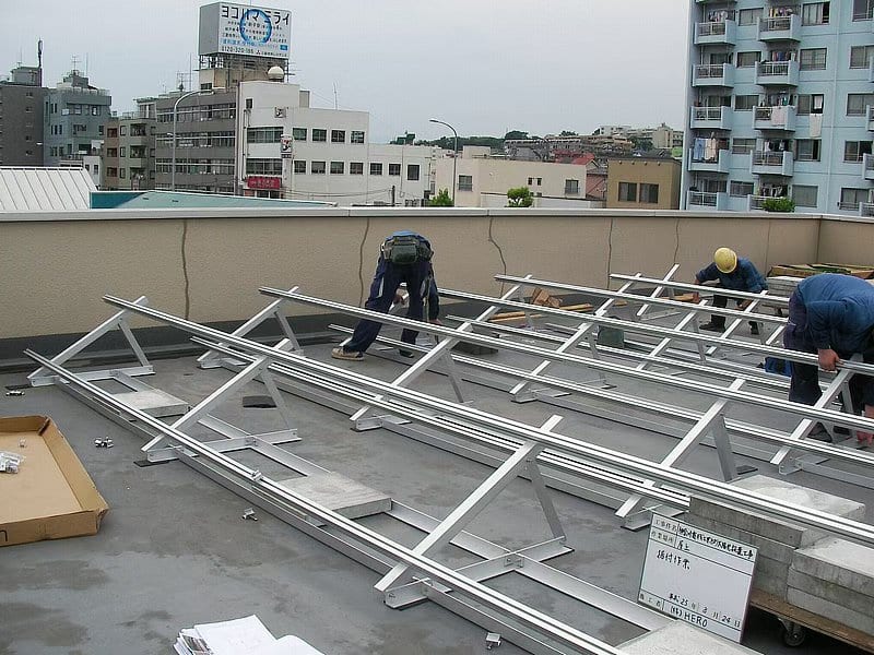Concrete roof solar installation in progress by workers