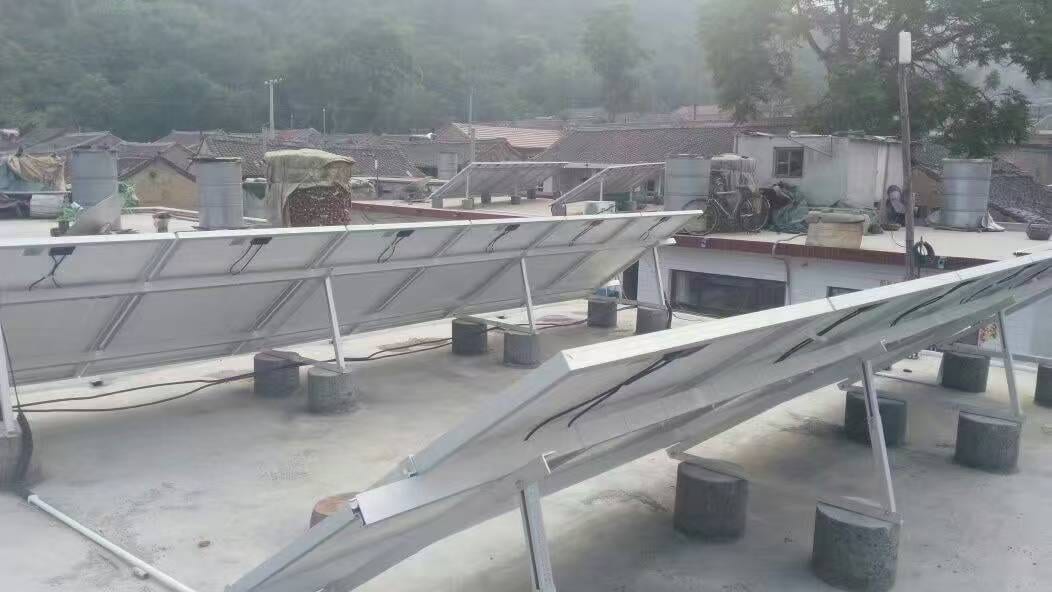 Rural concrete roof solar array with ballast blocks